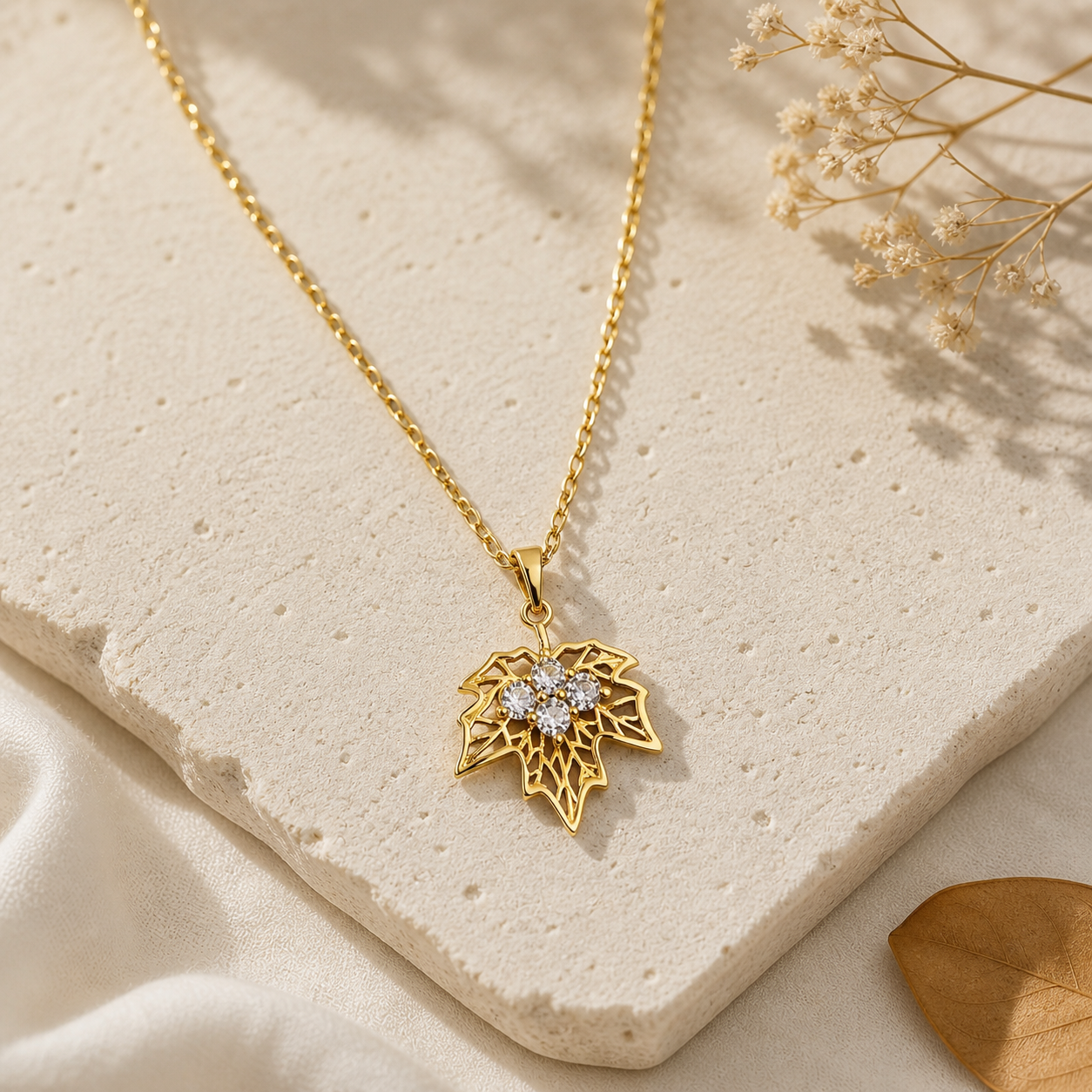 Minimalist gold pendant necklace with leaf design and crystal accents, aesthetic jewelry for everyday wear and gifting