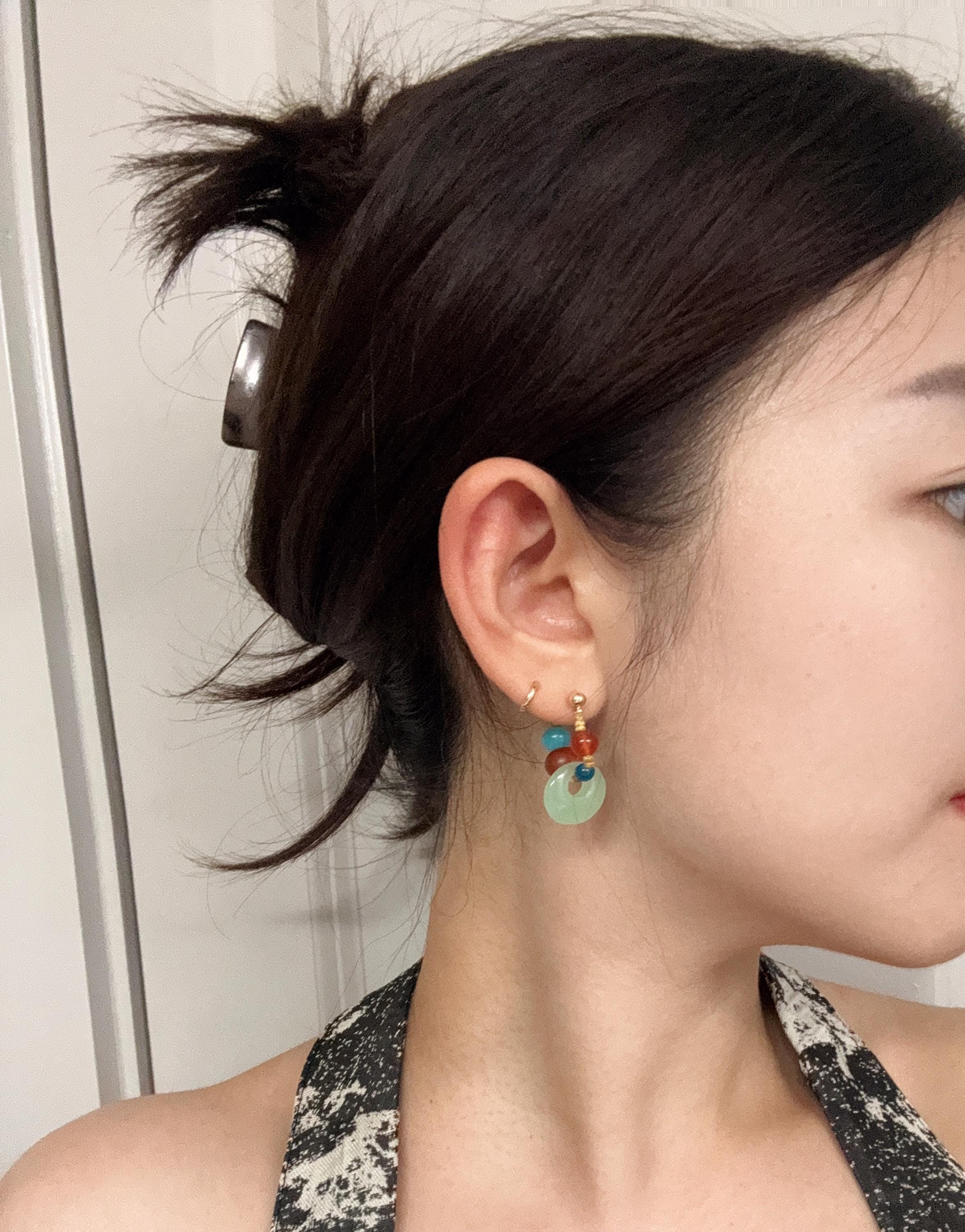Model wearing handmade aquamarine and red agate gemstone earrings