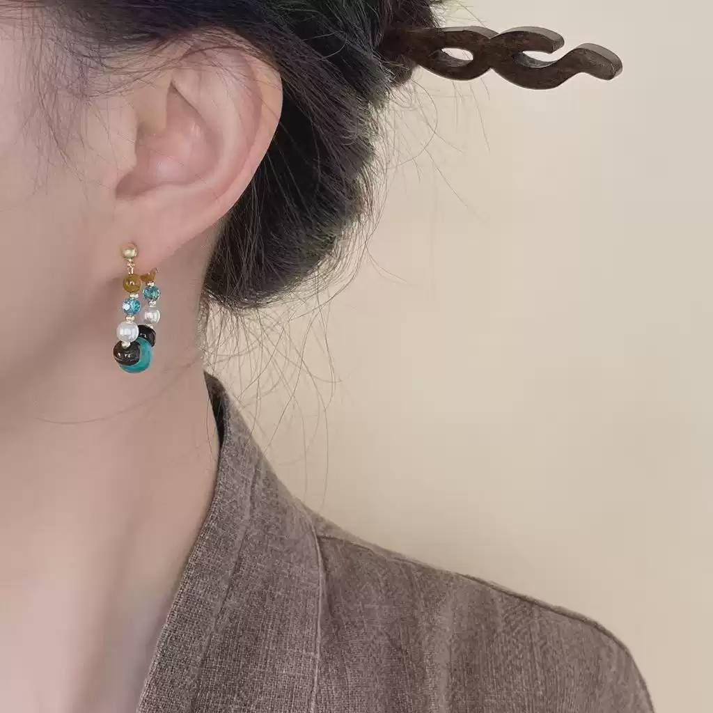 Elegant handmade aquamarine and red agate earrings worn by model
